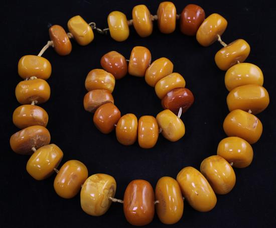 A single strand disc shaped amber bead necklace and matching bracelet, necklace 18.5in.
